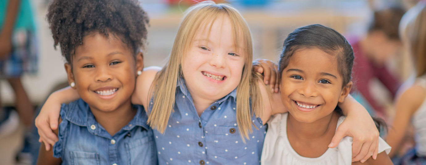 3 Girls Grinning With Their Arms Around Each Others Shoulders