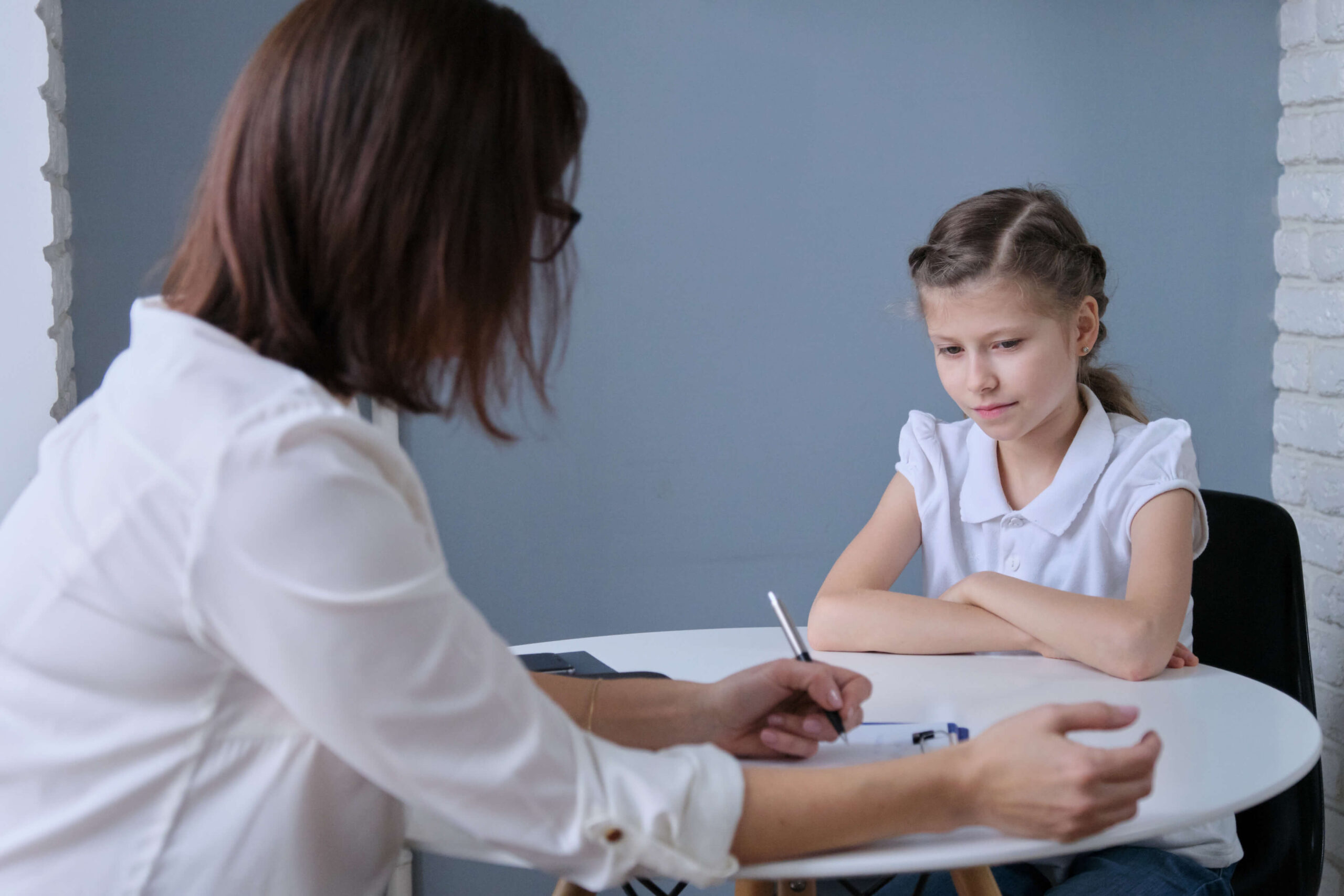 Young girl being interviewed by adult